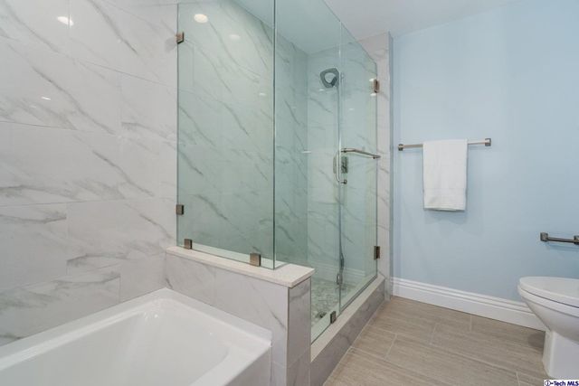 a sink with a cabinets and a potted plant