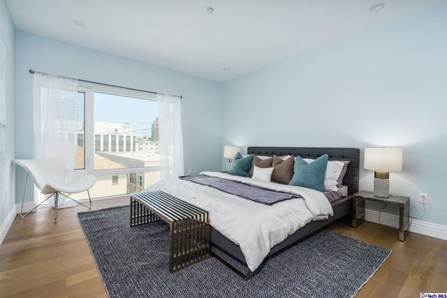 a bedroom with a bed a table and chair