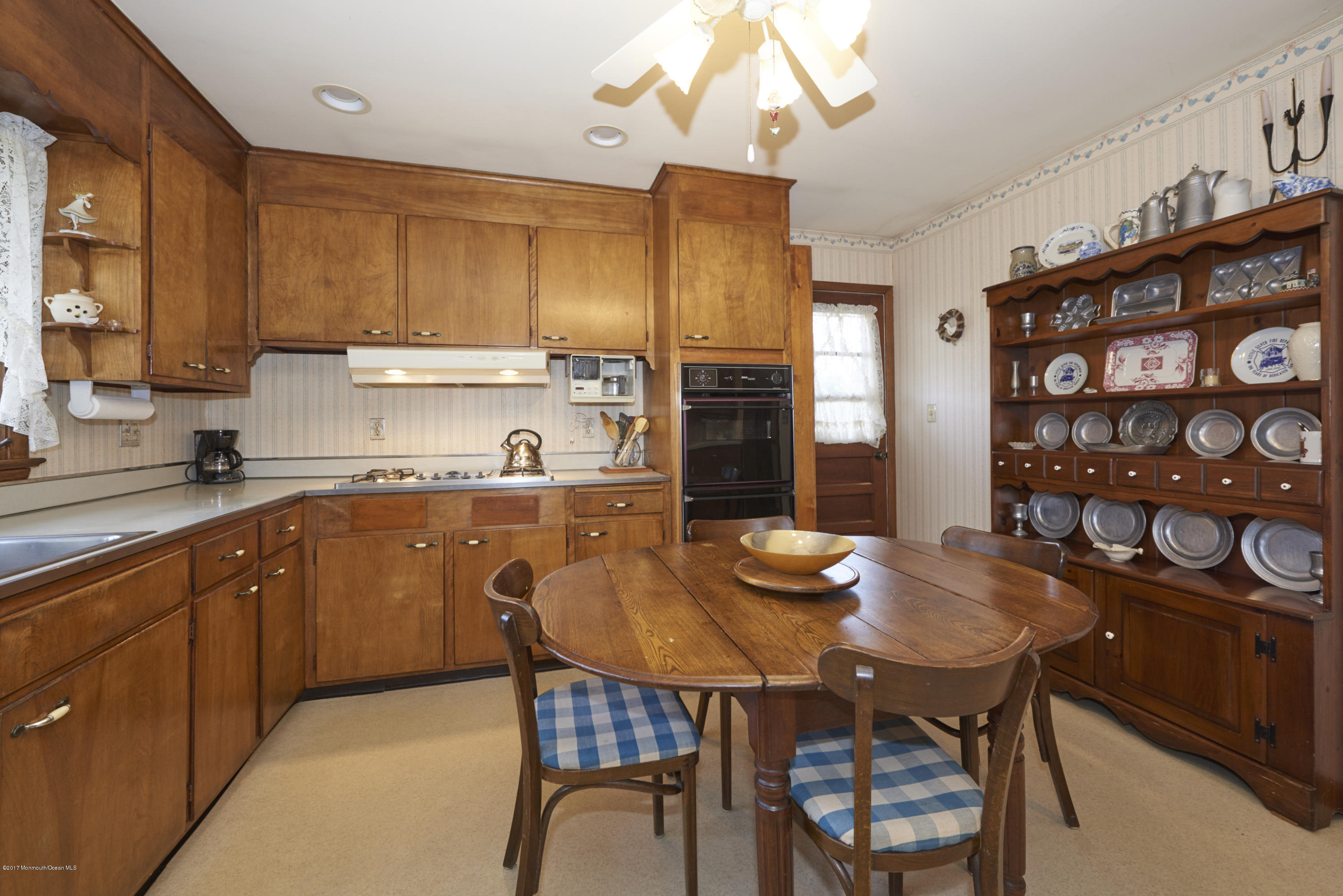 22 Maple Avenue Little Silver, NJ 07739 - Photo 6 of 25 a kitchen with stainless steel appliances granite countertop a dining table chairs and a refrigerator