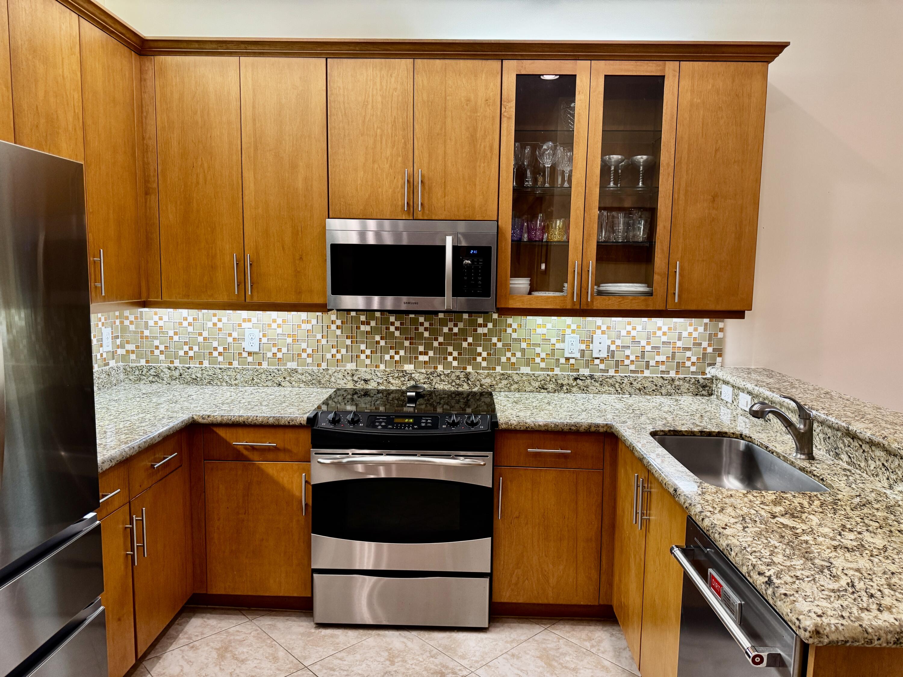 9385 Ivory Isle Road Boynton Beach, FL 33473 - Photo 5 of 50 a kitchen with a stove and a sink
