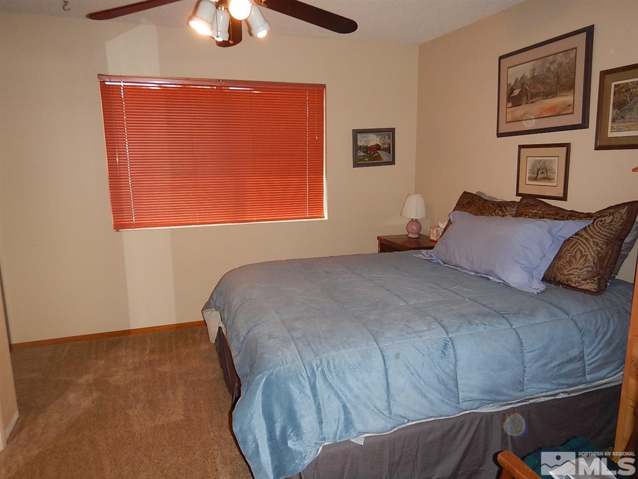 15292 Starr Grove Way Reno, NV 89521 - Photo 17 of 25 a bedroom with a bed and a chandelier