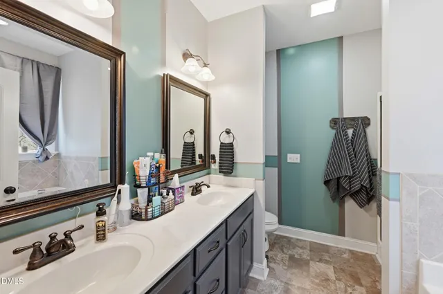 a bathroom with a sink double vanity and a mirror