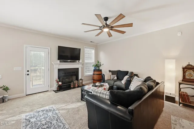 a living room with furniture a fireplace and a flat screen tv