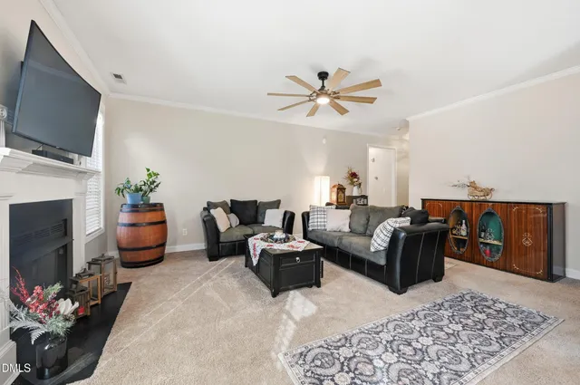 a living room with furniture fireplace and flat screen tv