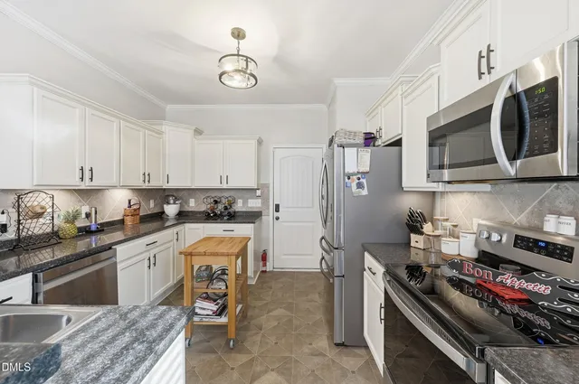 a kitchen with stainless steel appliances granite countertop a stove and a sink