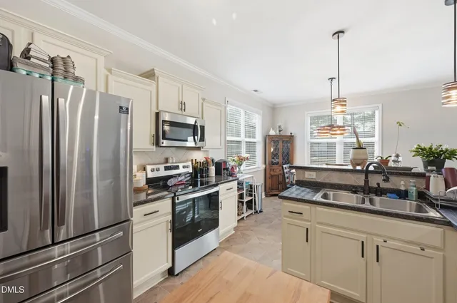 a kitchen with appliances a sink cabinets and a counter top space