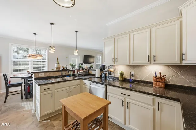 a kitchen with stainless steel appliances granite countertop a sink and cabinets