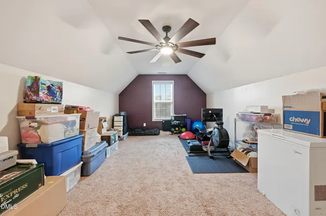 a view of a workspace with furniture and a ceiling fan