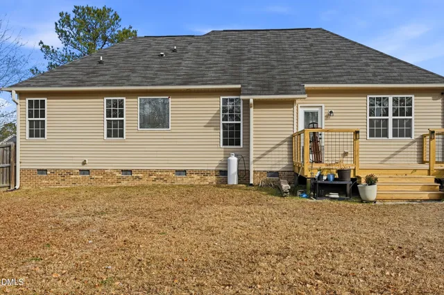 a front view of house with car parked