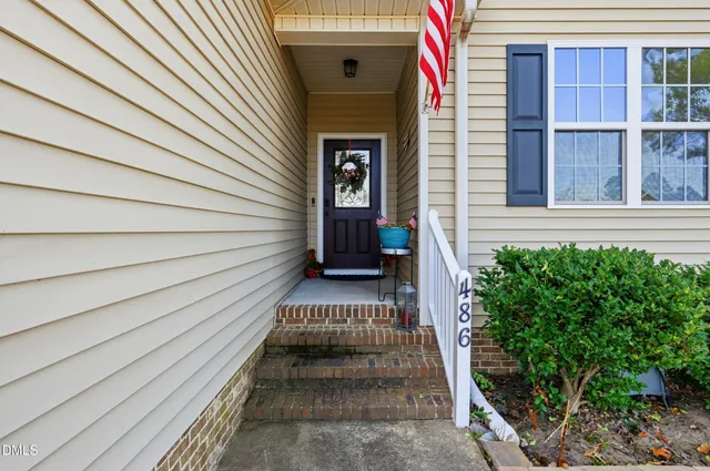 a view of a house with a door and wooden floor