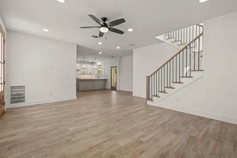 a kitchen with kitchen island granite countertop a sink cabinets and stainless steel appliances
