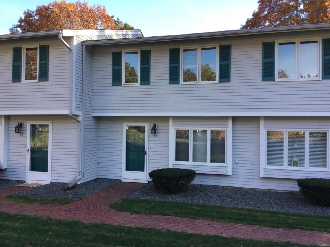 174 Lowell Road, Unit 57 Mashpee, MA 02649 - Photo 1 of 12 a brick house that has a small yard