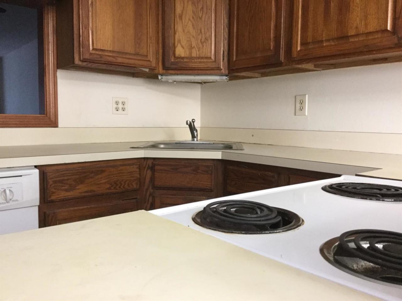 174 Lowell Road, Unit 57 Mashpee, MA 02649 - Photo 3 of 12 a kitchen with a sink a stove and cabinets