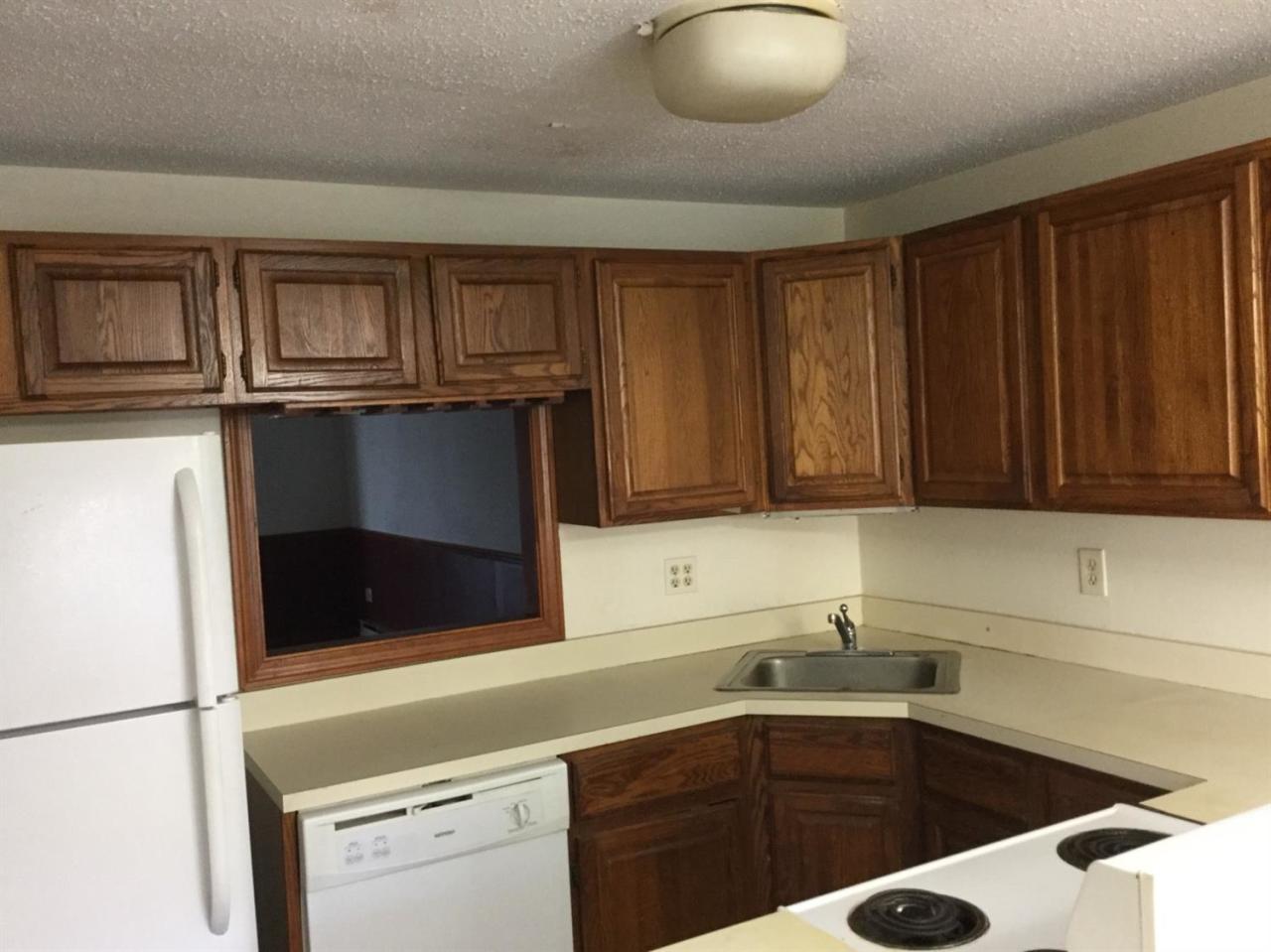174 Lowell Road, Unit 57 Mashpee, MA 02649 - Photo 4 of 12 a kitchen with stainless steel appliances granite countertop a sink and a microwave