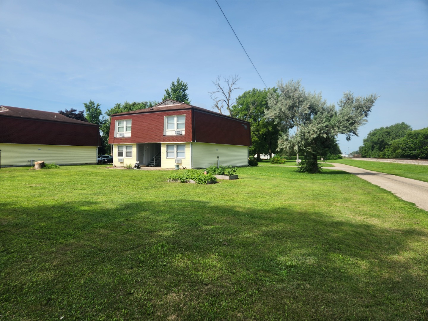 201-203 South Maple Street Toluca, IL 61369 - Photo 2 of 11 a view of a house with a yard