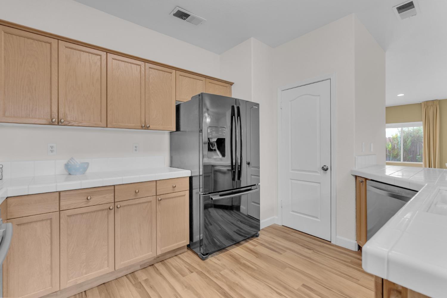 2573 Applegate Avenue Clovis, CA 93611 - Photo 11 of 26 a kitchen with white cabinets and stainless steel appliances