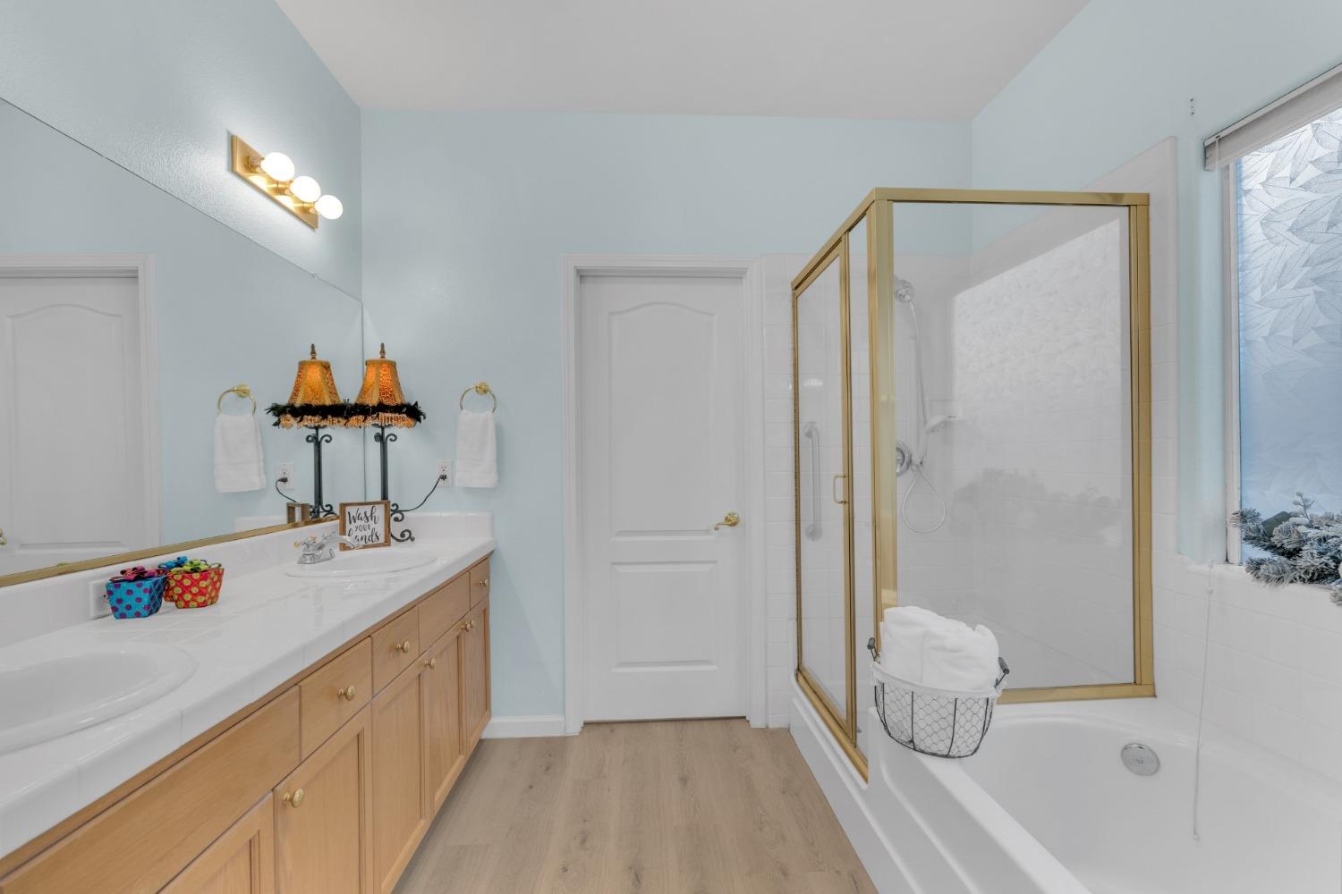 2573 Applegate Avenue Clovis, CA 93611 - Photo 13 of 26 a bathroom with a sink a toilet and shower