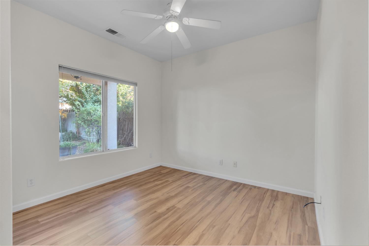 2573 Applegate Avenue Clovis, CA 93611 - Photo 15 of 26 an empty room with wooden floor and windows