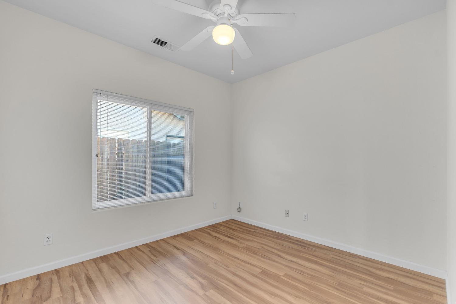 2573 Applegate Avenue Clovis, CA 93611 - Photo 17 of 26 wooden floor in an empty room with a window
