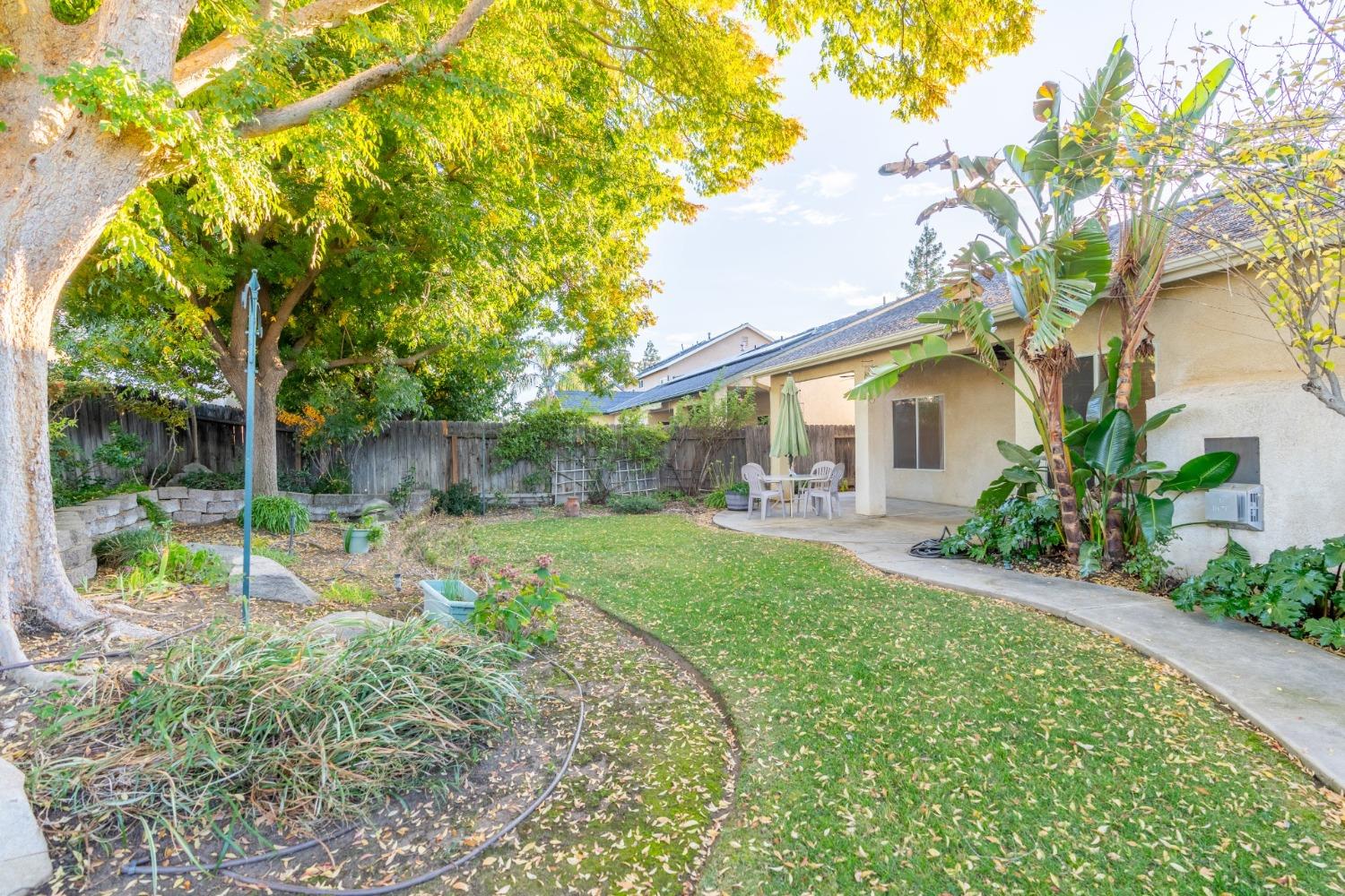2573 Applegate Avenue Clovis, CA 93611 - Photo 21 of 26 a view of backyard with table and chairs and potted plants