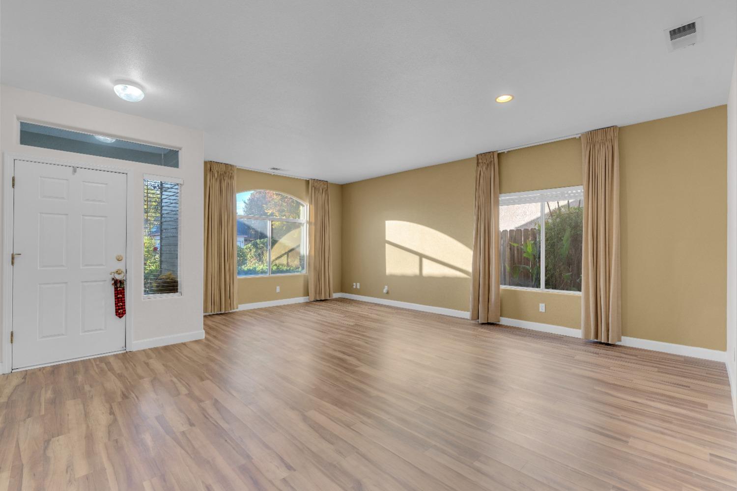 2573 Applegate Avenue Clovis, CA 93611 - Photo 4 of 26 a view of an empty room with wooden floor and a window