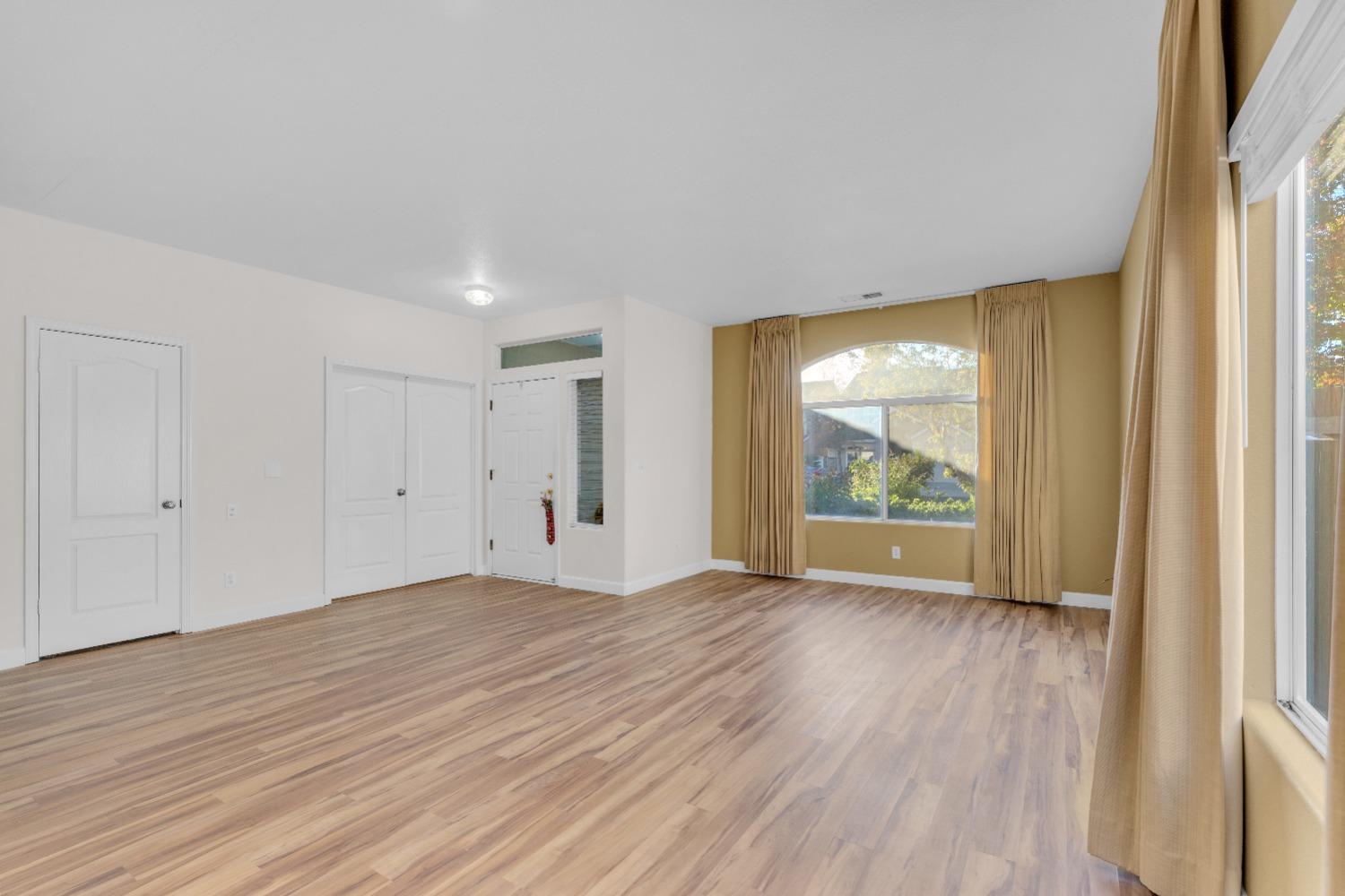 2573 Applegate Avenue Clovis, CA 93611 - Photo 5 of 26 a view of an empty room with a window and wooden floor