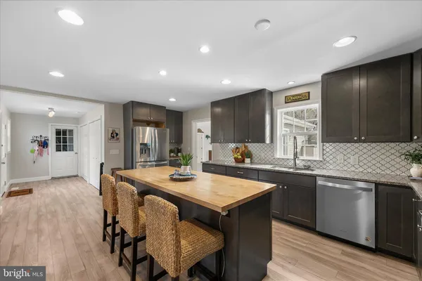 a kitchen with center island and stainless steel appliances