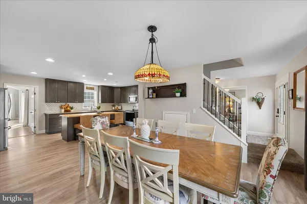 a dining room with furniture entryway and wooden floor