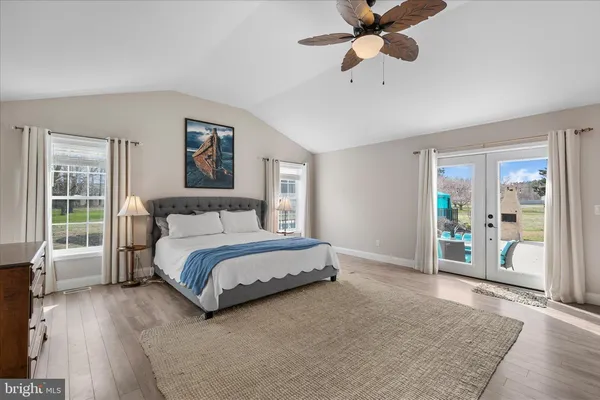 a spacious bedroom with a bed and a large window