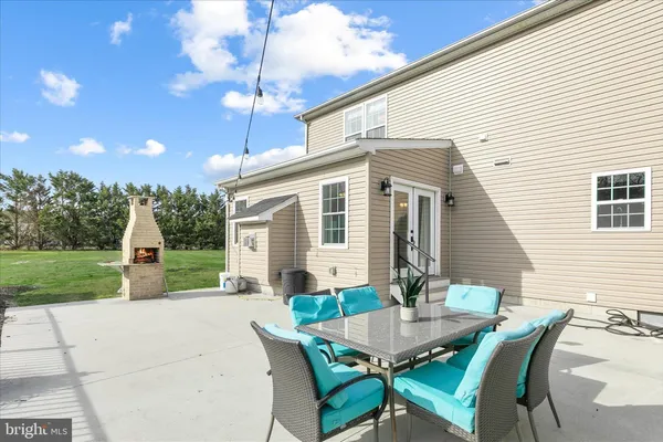 a view of swimming pool with outdoor seating and yard in the back