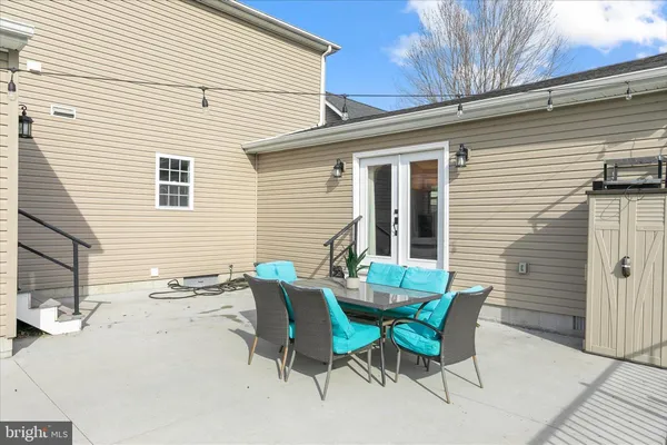 a view of a swimming pool with a patio and a yard