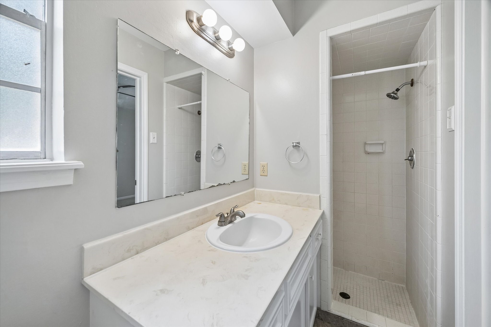 25114 Spring Ridge Drive Spring, TX 77386 - Photo 18 of 24 a bathroom with a sink a shower and a mirror