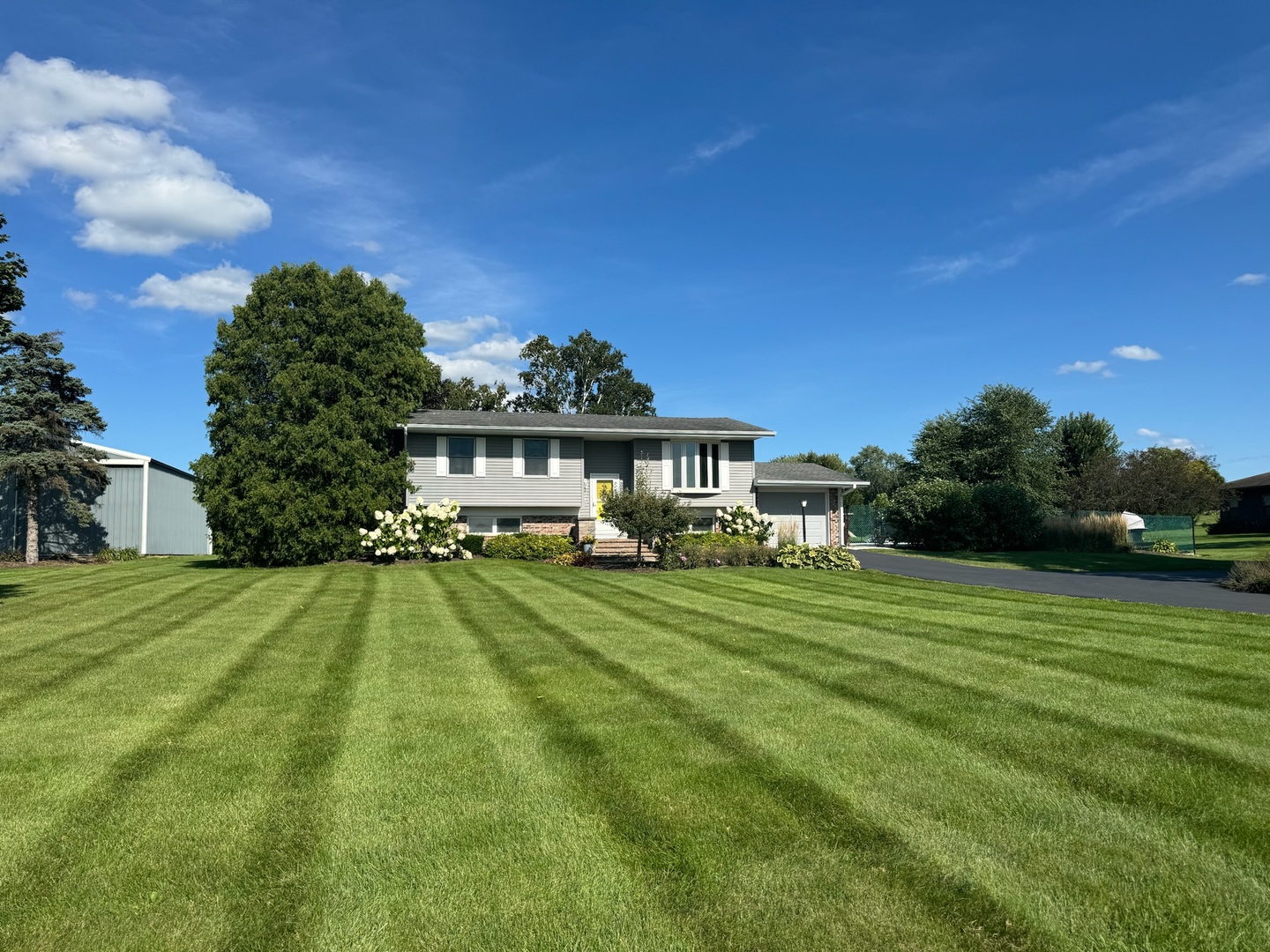 3308 Stieg Road Woodstock, IL 60098 - Photo 1 of 27 a front view of a house with a yard