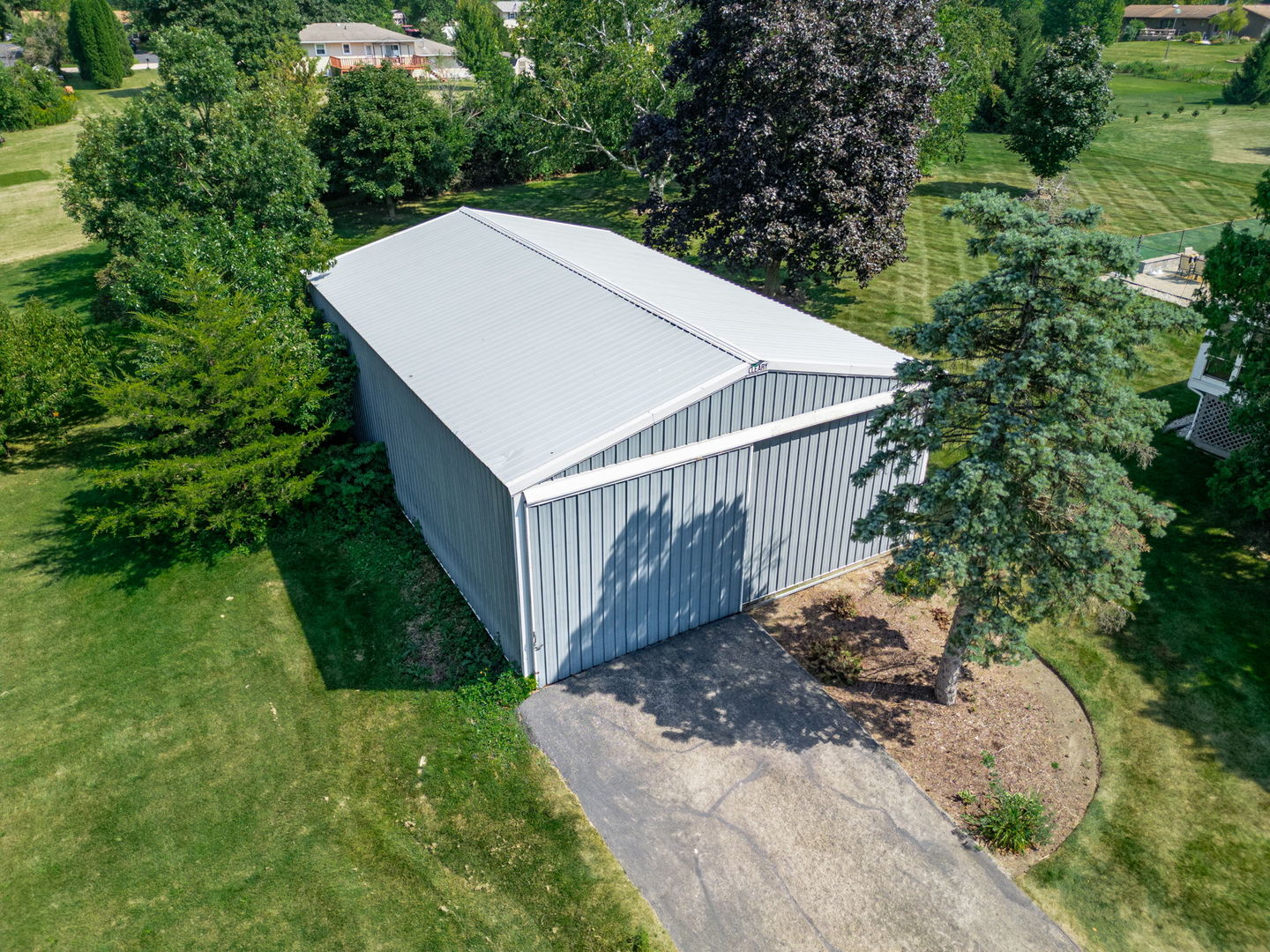 3308 Stieg Road Woodstock, IL 60098 - Photo 21 of 27 a view of a backyard with a white house