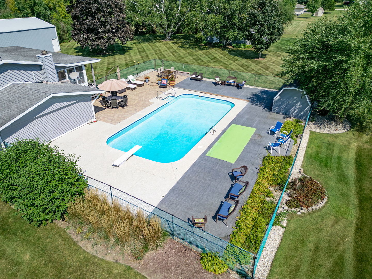 3308 Stieg Road Woodstock, IL 60098 - Photo 24 of 27 an aerial view of a swimming pool with a yard and outdoor seating