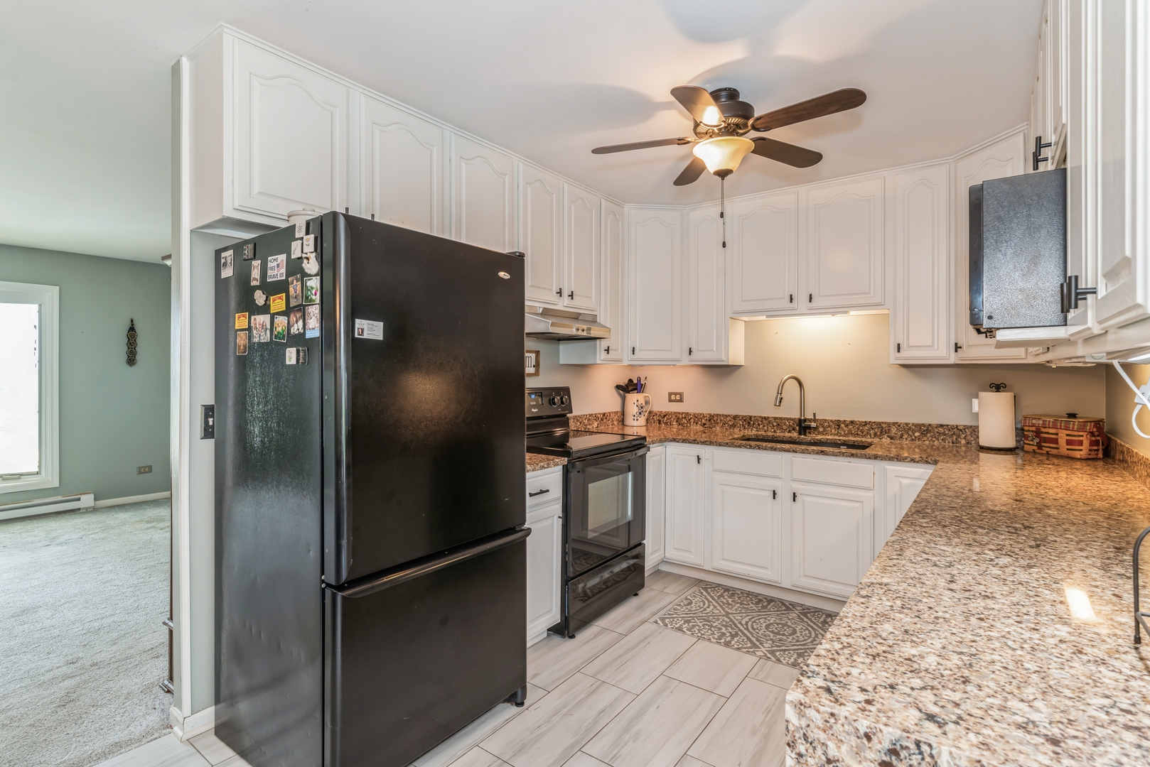 3308 Stieg Road Woodstock, IL 60098 - Photo 6 of 27 a kitchen with granite countertop stainless steel appliances a refrigerator a sink and cabinets