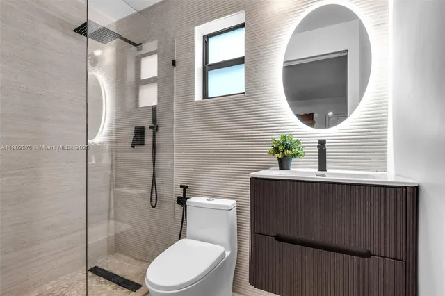 a bathroom with a toilet a sink and mirror