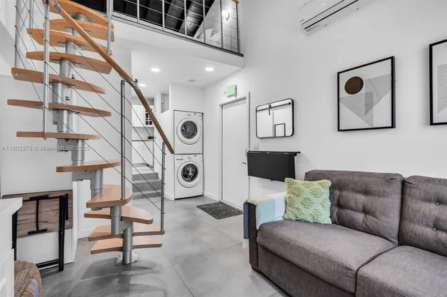 a living room with furniture and a rug