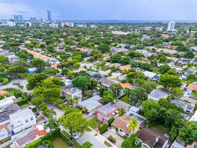 an aerial view of multiple house with yard