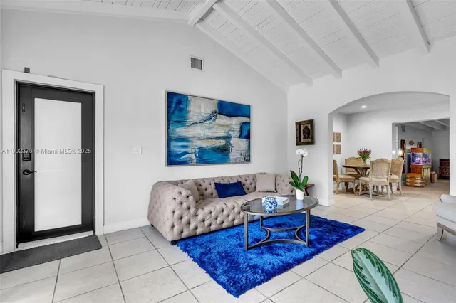 a living room with furniture rug and glass door