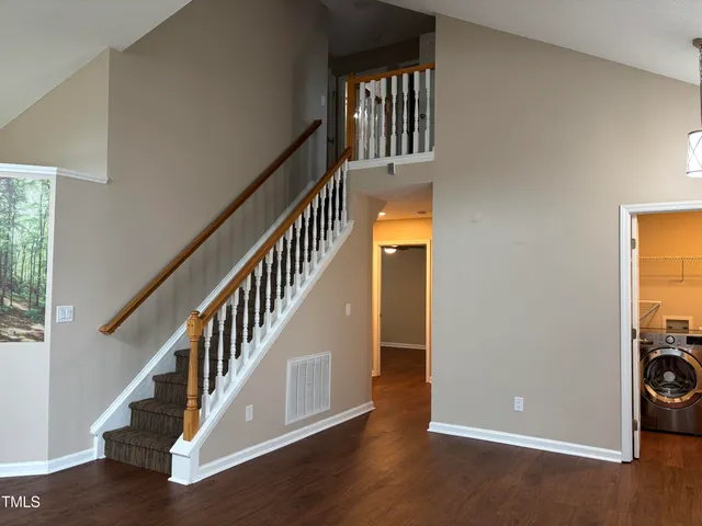 a view of a livingroom with wooden floor and a fireplace