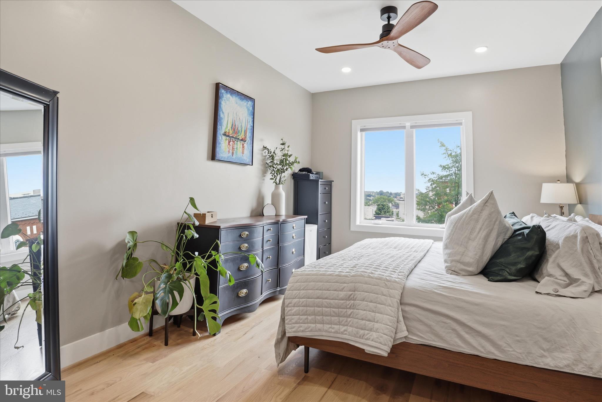 1222 Neal Street Northeast, Unit 3 Washington, DC 20002 - Photo 23 of 38 a bedroom with a bed potted plant with the outer view