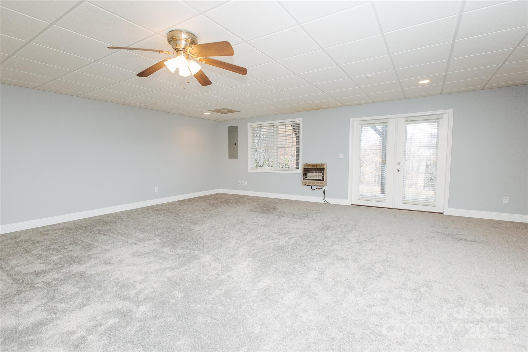89 Bobcat Path Marion, NC 28752 - Photo 11 of 48 an empty room with chandelier fan and windows