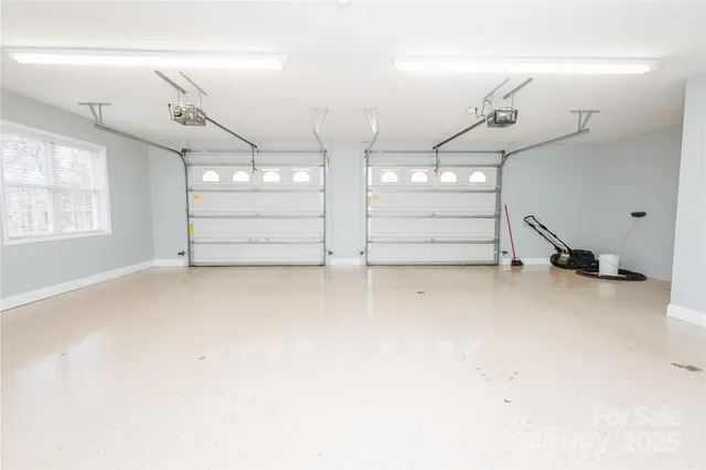 a view of empty room with wooden floor and windows