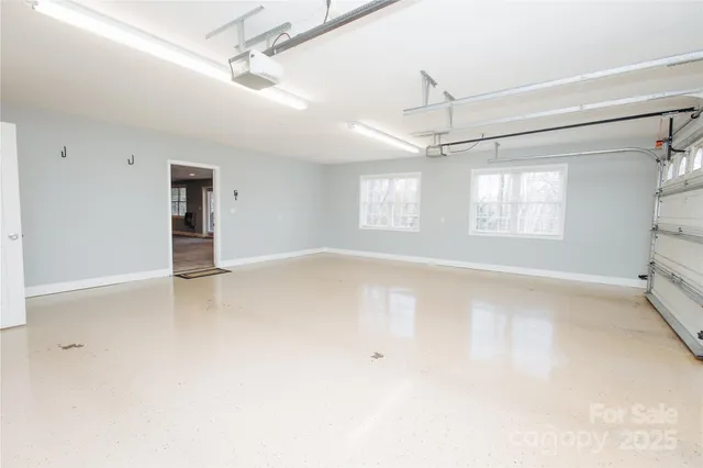 a view of empty room with wooden floor and fireplace
