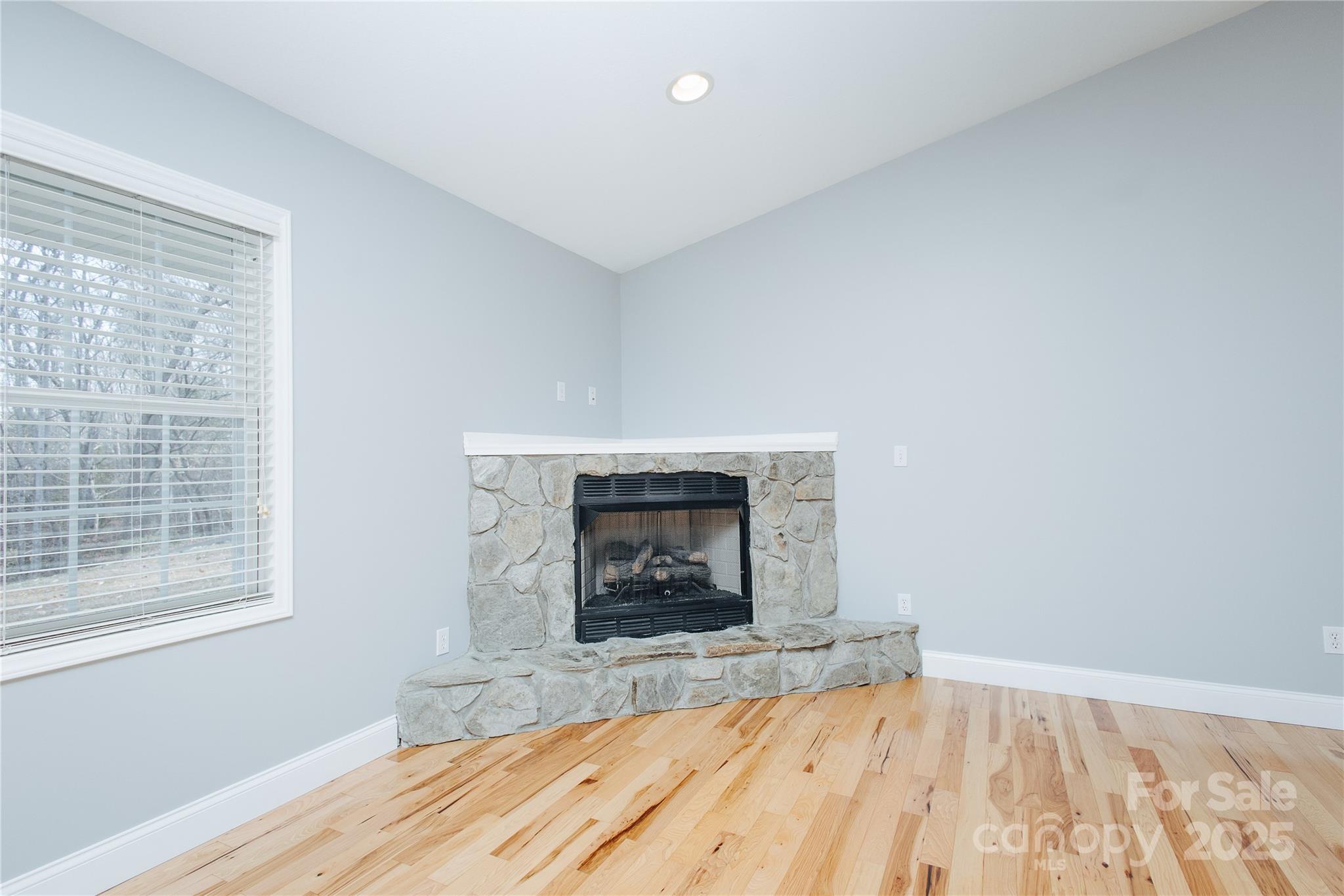 89 Bobcat Path Marion, NC 28752 - Photo 15 of 48 a view of empty room with wooden floor and fireplace