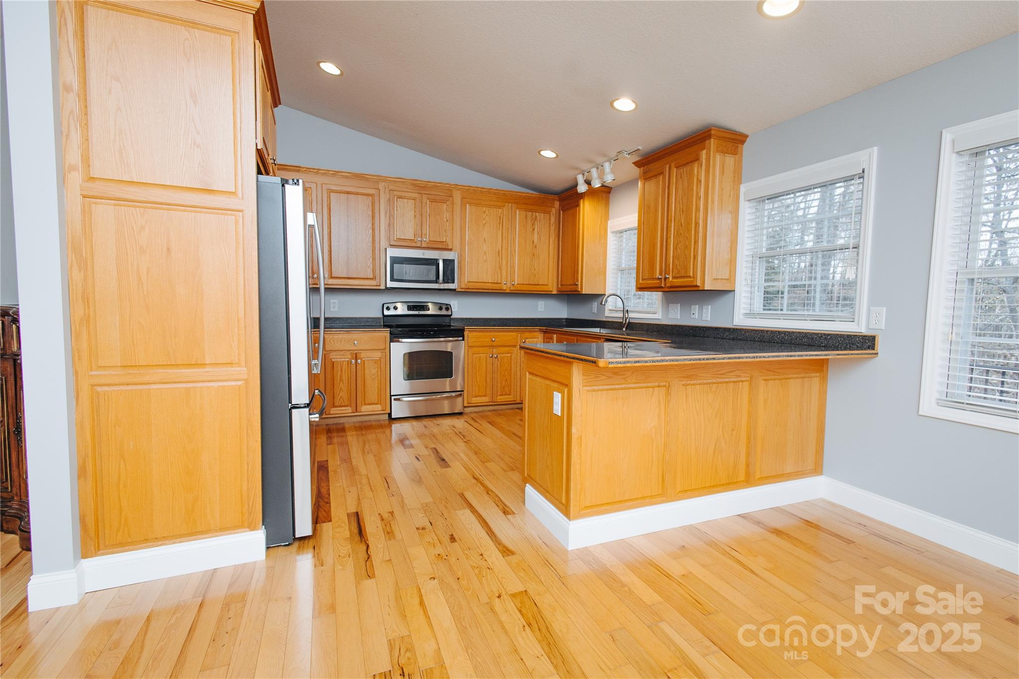 89 Bobcat Path Marion, NC 28752 - Photo 22 of 48 a kitchen with stainless steel appliances granite countertop a refrigerator a stove top oven and a sink with granite countertops