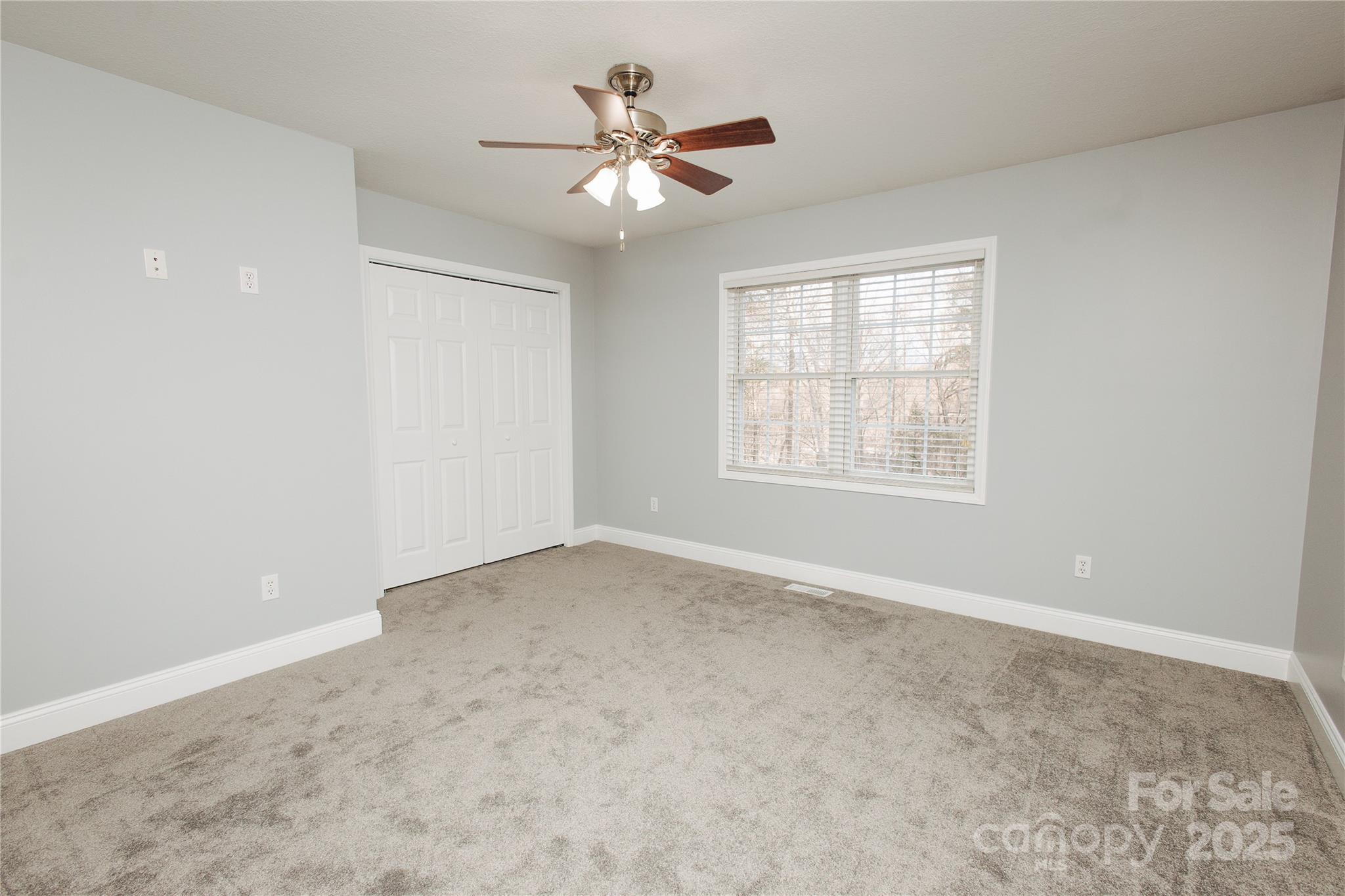 89 Bobcat Path Marion, NC 28752 - Photo 25 of 48 an empty room with a window and a ceiling fan