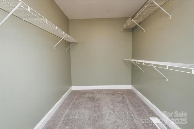 an empty room with a ceiling fan and a window