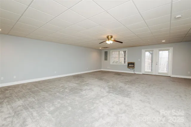 an empty room with windows and pillars in it